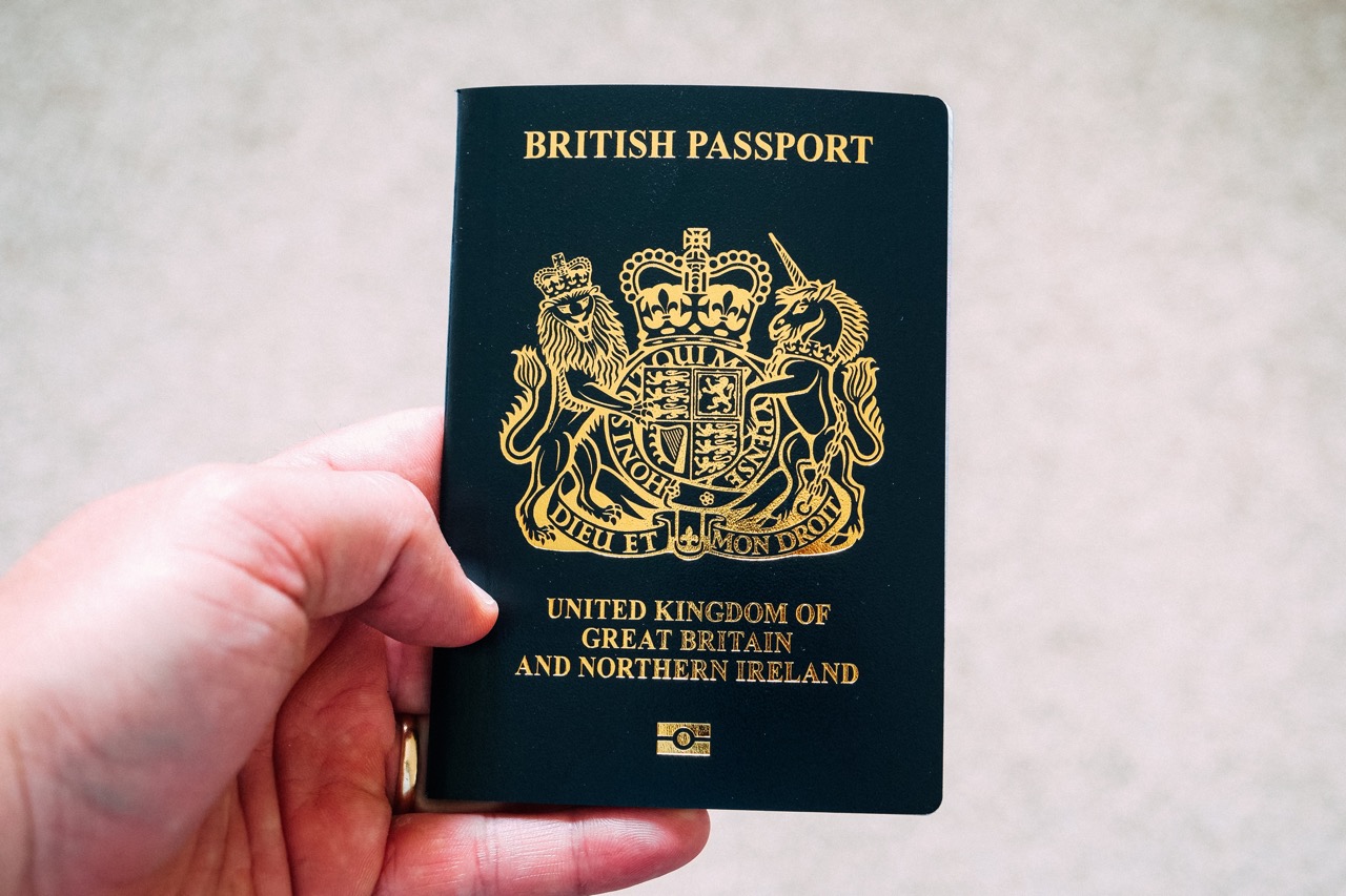 person holding UK passport